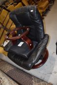 An Ekornes stressless lounge chair and footstool, in black