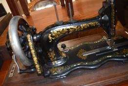 An antique hand cranked sewing machine by Kimball and Morton Glasgow