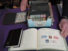 A box containing 300+ small stock cards and three small albums of Commonwealth Stamps, mint &