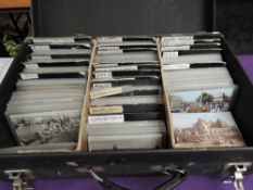A large collection of vintage World Post Cards in suitcase, including France, Egypt, Russia etc, all