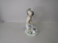 A Lladro Figurine, In A Tropical Garden (Hawaiian girl with flowers kneeling) model no 1479