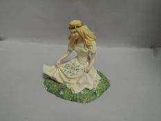 A Boarder Fine arts style figure study of a seated maiden in flower field