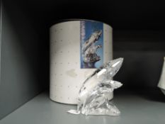A crystal glass Swarovski figure study of a Whale group ' Care for Me' with case