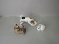 A collection of figure studies including Royal Doulton Jack Russel eating from plate, USSR Rabbit