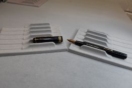 A Conway Stewart 388 leverfill fountain pen in black with one medium and two narrow bands to the cap