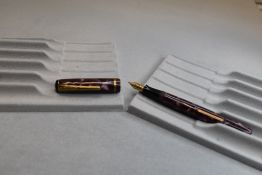 A Burnham 44 leverfill fountain pen in rose pink marble with single narrow band to cap having