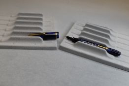A Conway Stewart Dinkie 550 leverfill fountain pen in blue/ black marble with single band to the cap