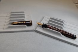 A Parker Vacumatic button fill fountain pen in brown transparant with three narrow bands to the