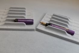 A Conway Stewart Dinkie Major 640 leverfill fountain pen in purple with ring cap having a Conway