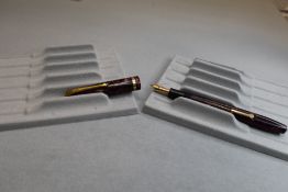 A Conway Stewart 12 leverfill fountain pen in red marble with single band to the cap having a Conway