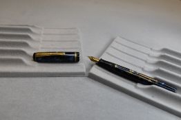 A Burnham 44 leverfill fountain pen in blue and grey with gold veining with single narrow band to