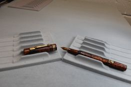 A Conway Stewart 494M leverfill fountain pen in mottled red with two narrow bands to the cap