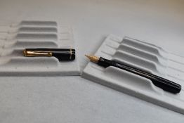 A Parker Moderne button fill fountain pen in black with single band to cap having Parker 14k nib .