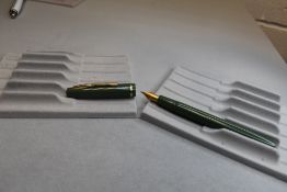 A Burnham vacuum fill fountain pen in green with single band to the cap having Osmiroid nib.