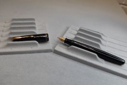 A Parker Vacumatic button fill fountain pen in black with three narrow bands to the cap having a