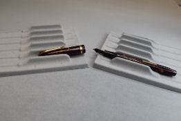 A Conway Stewart 12 leverfill fountain pen in red marble with single band to the cap having a Conway