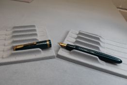A Parker Duofold vacuum fill fountain pen in green with single decorated band to cap having a Parker