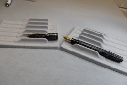 A Burnham 48 leverfill fountain pen in grey with black veining with single band to cap having