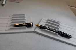 A Parker Duofold button fill fountain pen in black and grey marble having decorated band to cap with