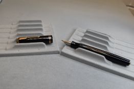 A Parker Vacumatic button fill fountain pen in black with three narrow bands to the cap having a