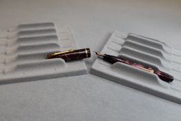 A Conway Stewart Dinkie 550 leverfill fountain pen in red marble with single band to the cap