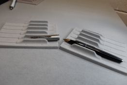 A Parker 65 vacuum fill fountain pen in black with brushed steel cap. Approx 13.5cm