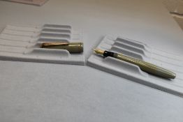 A Parker Victory button fill fountain pen in sage green with two narrow bands to the cap having a