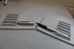 A Sheaffer Targa fountain pen in brushed metal with Sheaffer USA nib in box. Approx 13.5cm