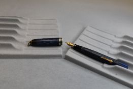 A Burnham leverfill fountain pen in blue with three narrow bands to cap and ring having Burnham