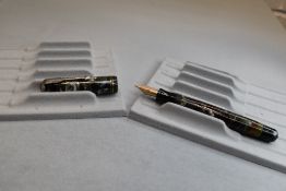 A Parker Vacumatic button fill fountain pen in grey, red and pearl marble with two narrow bands to