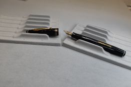 A Parker Parkette leverfill fountain pen in black with three narrow bands to cap and having a