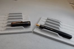 A Parker Duette button fill fountain pen in black with single band to cap having Parker 20 nib.