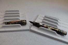 A Parker Parkette Deluxe leverfill fountain pen in Grey and black with red veining with three narrow