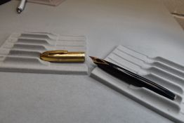 A Sheaffer PFM VI snorkel fill fountain pen in black with gold cap having Sheaffer 14ct nib.