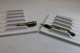 A Conway Stewart Dinkie 550 leverfill fountain pen in green marble with single band to the cap