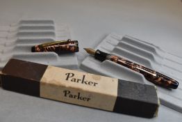 A Parker Parkette lever fill fountain pen in brown marble eith two narrow bands to the cap and
