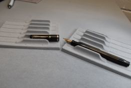 An early Parker Duofold button fill in BHR (discoloured) having Parker Duofold nib. Approx 13.5cm