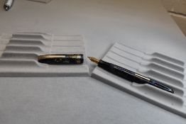 A Burnham B59 leverfill fountain pen in blue and grey with gold veining with three narrow bands to