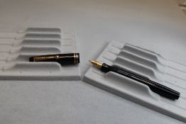 A Parker Duofold button fill fountain pen in black with two bands to the cap having a Parker Duofold