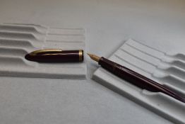 A Sheaffer Cadet (or similar stamped COMMANDO) plunger fill fountain pen in burgundy with a broad