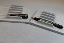 A Parker Televisor button fill fountain pen in green and black hatch with three narrow bands to
