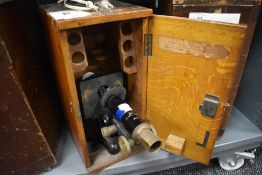 A scientific microscope in fitted case by Kima