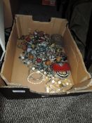 A box of mixed costume jewellery,trinket box,nurses watch and more.