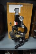 A scientific microscope in fitted case by Kima