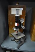 A scientific microscope in fitted case by Kima
