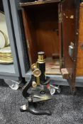 A scientific microscope in fitted case by Kima