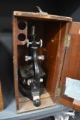 A scientific microscope in fitted case by Kima