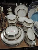 A Royal Grafton partial dinner service 'Majestic' having white ground with green band and gilt