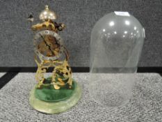 A Skeleton clock in glass dome, marked Thwaites and reed.
