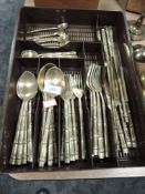 A collection of brass cutlery having bamboo effect handles.